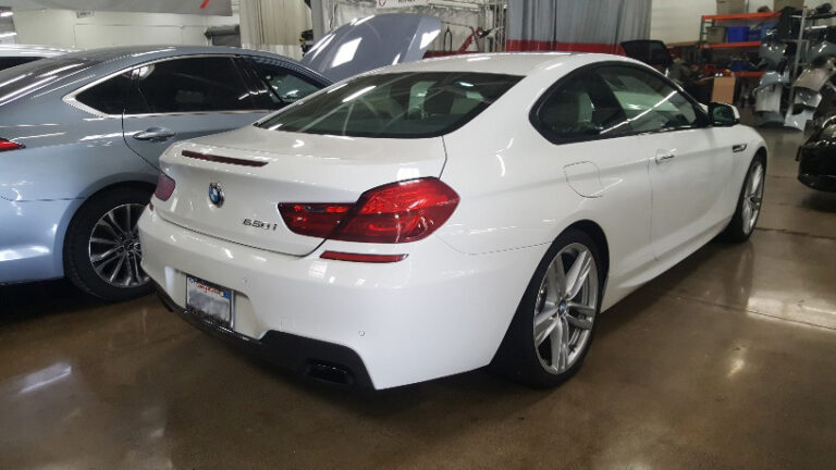 BMW in an auto body shop for scratch repair, paint correction, and professional refinishing